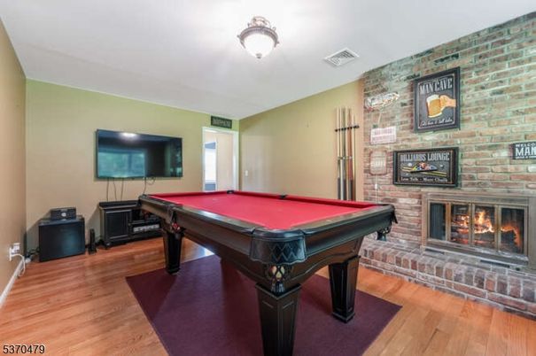 Billiard Table, Fireplace, Game Room, Interior, Stone Walls, Wood Texture Flooring