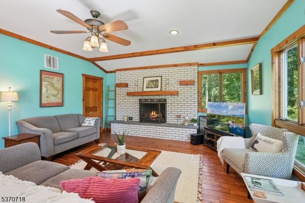 Fireplace, Interior, Living room, Recessed Lighting, Stone Walls, Wood Texture Flooring