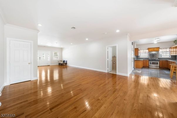 Empty room, Interior, Kitchen, Recessed Lighting, Stainless Steel Appliances, Wood Texture Flooring