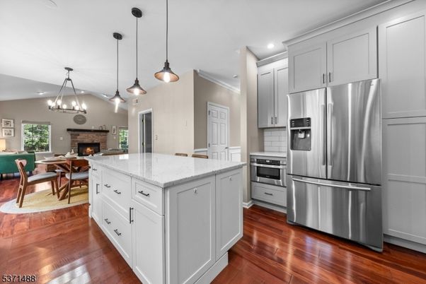 Dining room, Fireplace, Interior, Kitchen, Living room, Pendant Lights, Recessed Lighting, Stainless Steel Appliances, Wood Texture Flooring