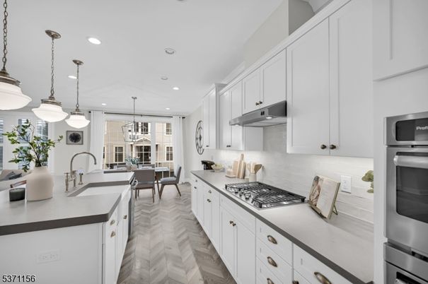 Chandelier, Dining room, Interior, Kitchen, Pendant Lights, Recessed Lighting, Stainless Steel Appliances, Wood Texture Flooring