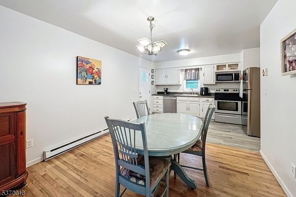 Chandelier, Dining room, Interior, Kitchen, Pendant Lights, Stainless Steel Appliances, Wood Texture Flooring