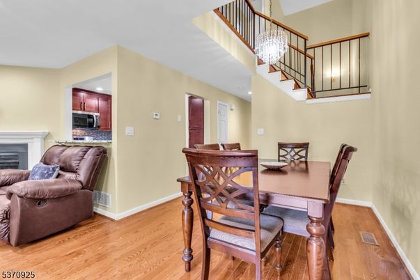 Chandelier, Dining room, Fireplace, Interior, Kitchen, Recessed Lighting, Wood Texture Flooring