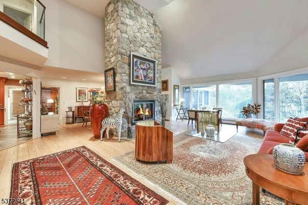 Dining room, Fireplace, Interior, Living room, Recessed Lighting, Stone Walls, Wood Texture Flooring
