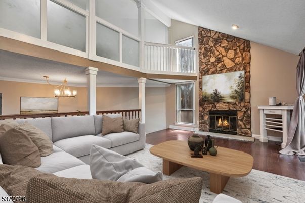 Chandelier, Fireplace, Interior, Living room, Recessed Lighting, Stone Walls, Wood Texture Flooring