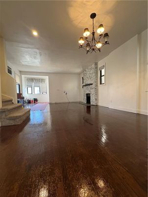 Chandelier, Empty room, Fireplace, Interior, Recessed Lighting, Stone Walls, Wood Texture Flooring