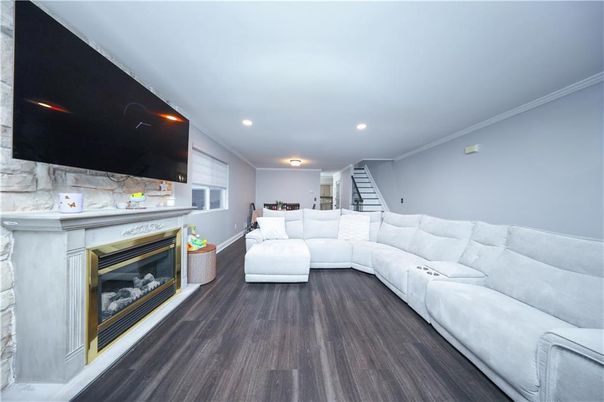 Fireplace, Interior, Living room, Marble Walls, Recessed Lighting, Wood Texture Flooring