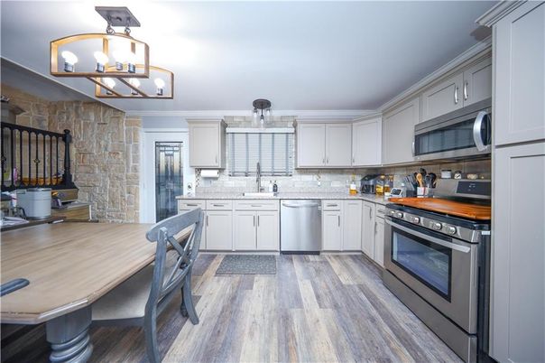Dining room, Interior, Kitchen, Pendant Lights, Stainless Steel Appliances, Stone Walls, Wood Texture Flooring
