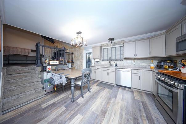 Chandelier, Dining room, Interior, Kitchen, Pendant Lights, Stainless Steel Appliances, Wood Texture Flooring