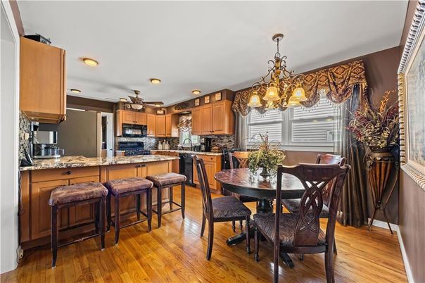 Chandelier, Dining room, Interior, Kitchen, Recessed Lighting, Stainless Steel Appliances, Wood Texture Flooring