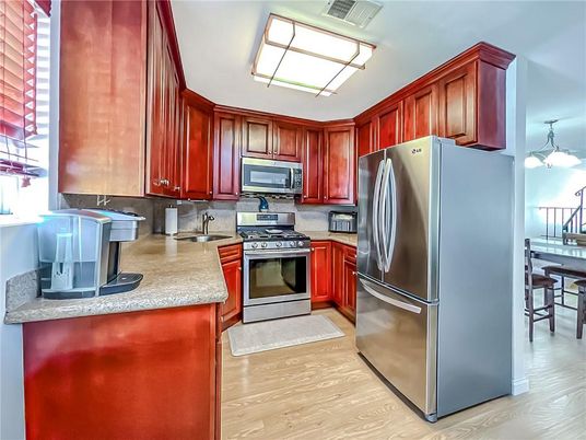 Chandelier, Dining room, Interior, Kitchen, Pendant Lights, Stainless Steel Appliances, Wood Texture Flooring