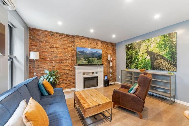 Fireplace, Interior, Living room, Recessed Lighting, Stone Walls, Wood Texture Flooring