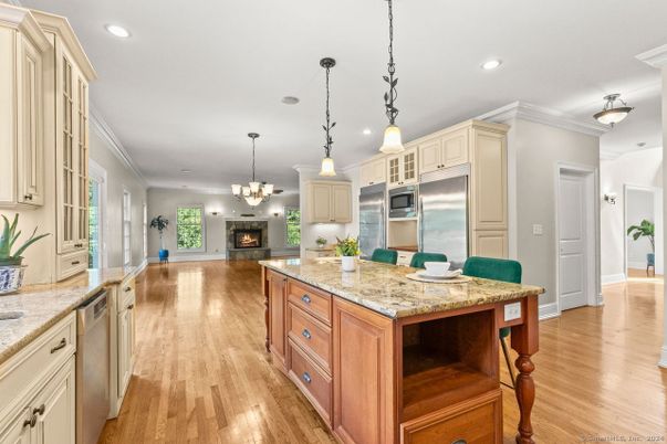 Chandelier, Fireplace, Interior, Kitchen, Pendant Lights, Recessed Lighting, Stainless Steel Appliances, Wood Texture Flooring