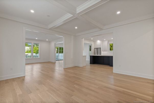 Empty room, Interior, Kitchen, Recessed Lighting, Stainless Steel Appliances, Wood Texture Flooring