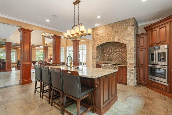 Chandelier, Interior, Kitchen, Pendant Lights, Recessed Lighting, Stainless Steel Appliances, Stone Walls