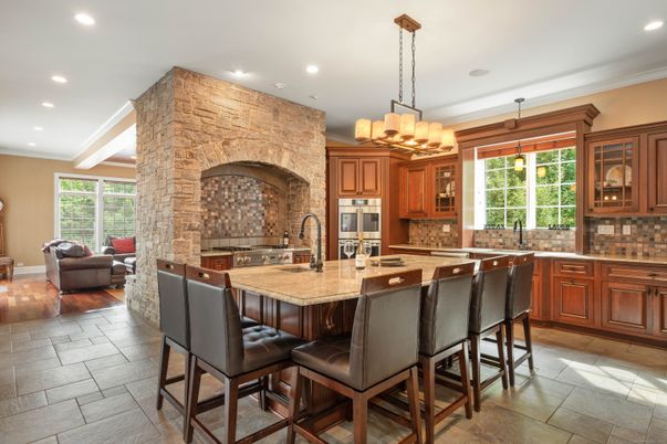 Chandelier, Fireplace, Interior, Kitchen, Living room, Recessed Lighting, Stainless Steel Appliances, Stone Walls