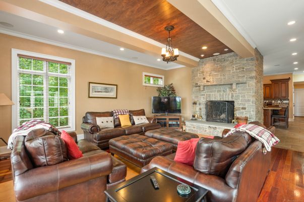 Chandelier, Fireplace, Interior, Living room, Recessed Lighting, Stone Walls, Wooden Ceilings, Wood Texture Flooring