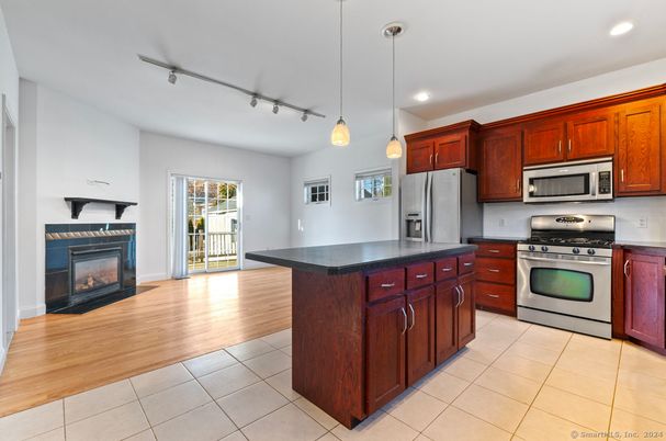 Fireplace, Interior, Kitchen, Pendant Lights, Recessed Lighting, Stainless Steel Appliances, Wood Texture Flooring