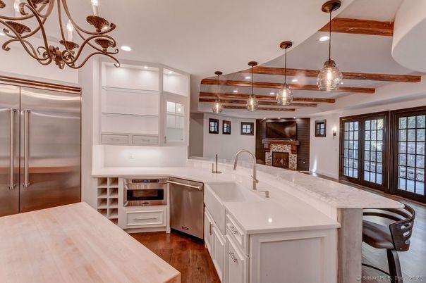 Fireplace, Interior, Kitchen, Pendant Lights, Recessed Lighting, Stainless Steel Appliances, Wooden Beams, Wood Texture Flooring