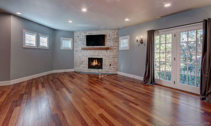 Empty room, Fireplace, Interior, Recessed Lighting, Stone Walls, Wood Texture Flooring