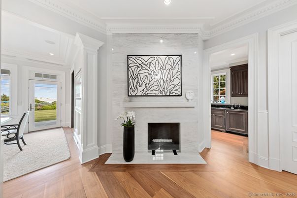 Fireplace, Interior, Marble Walls, Recessed Lighting, Wood Texture Flooring