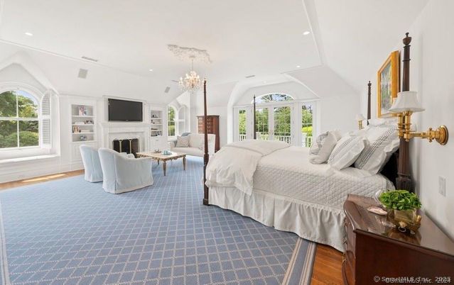 Bedroom, Chandelier, Fireplace, Interior, Recessed Lighting, Wood Texture Flooring