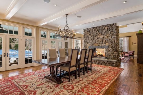 Chandelier, Dining room, Fireplace, Interior, Recessed Lighting, Stone Walls, Wood Texture Flooring