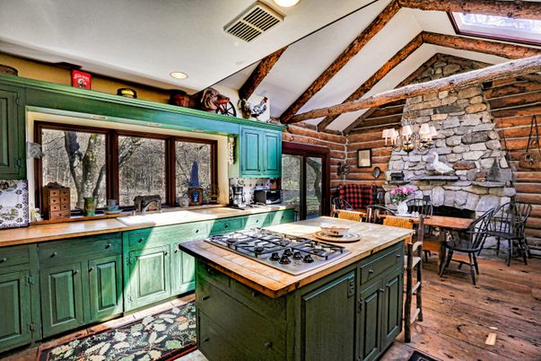 Chandelier, Dining room, Fireplace, Interior, Kitchen, Recessed Lighting, Stainless Steel Appliances, Stone Walls, Wooden Beams, Wood Texture Flooring