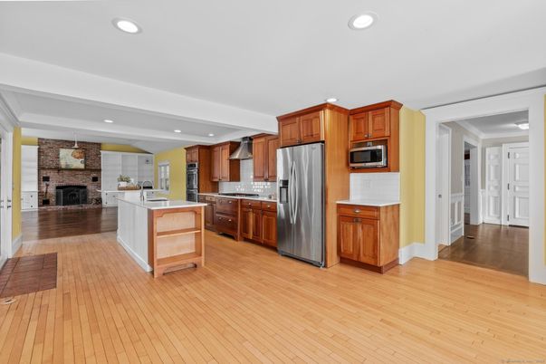 Fireplace, Interior, Kitchen, Recessed Lighting, Stainless Steel Appliances, Stone Walls, Wood Texture Flooring