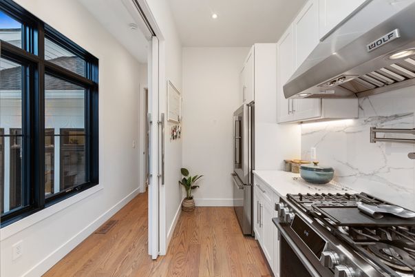Interior, Kitchen, Marble Walls, Recessed Lighting, Stainless Steel Appliances, Wood Texture Flooring
