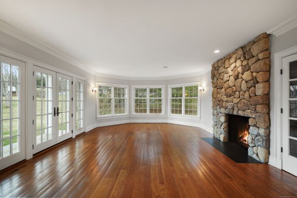 Empty room, Fireplace, Interior, Recessed Lighting, Stone Walls, Wood Texture Flooring
