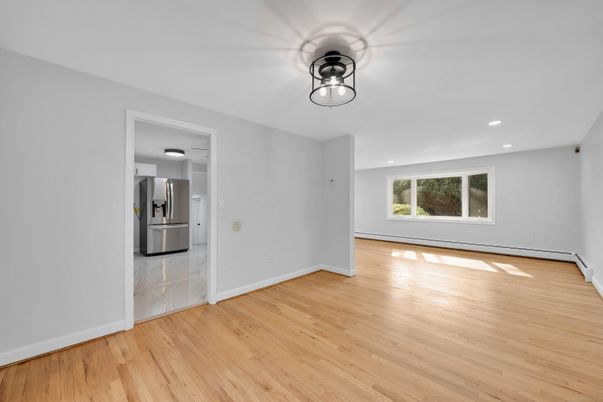 Empty room, Interior, Kitchen, Recessed Lighting, Stainless Steel Appliances, Wood Texture Flooring