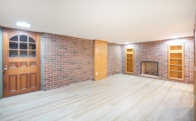 Empty room, Fireplace, Interior, Recessed Lighting, Stone Walls, Wood Texture Flooring