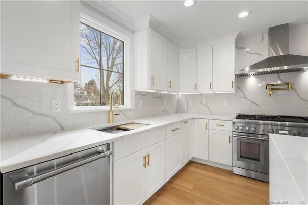 Interior, Kitchen, Marble Walls, Recessed Lighting, Stainless Steel Appliances, Wood Texture Flooring