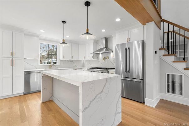 Interior, Kitchen, Marble Walls, Pendant Lights, Recessed Lighting, Stainless Steel Appliances, Wood Texture Flooring