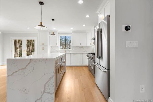 Interior, Kitchen, Marble Walls, Pendant Lights, Recessed Lighting, Stainless Steel Appliances, Wood Texture Flooring