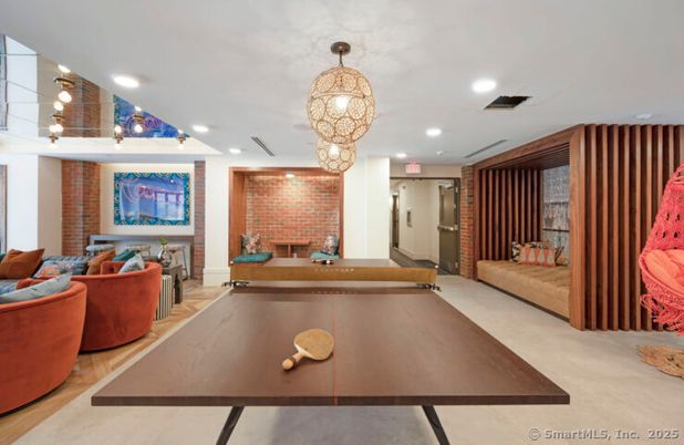 Chandelier, Fireplace, Interior, Living room, Pendant Lights, Recessed Lighting, Stone Walls, Wood Texture Flooring