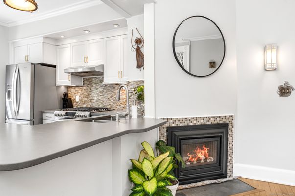 Fireplace, Interior, Kitchen, Recessed Lighting, Stainless Steel Appliances, Wood Texture Flooring