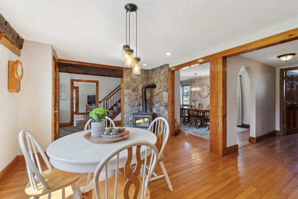 Chandelier, Dining room, Fireplace, Interior, Pendant Lights, Recessed Lighting, Stone Walls, Wood Texture Flooring