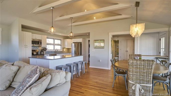 Chandelier, Dining room, Interior, Kitchen, Living room, Pendant Lights, Recessed Lighting, Stainless Steel Appliances, Wood Texture Flooring