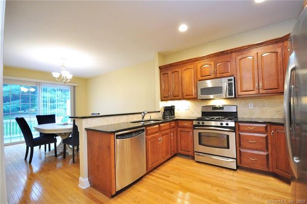 Chandelier, Dining room, Interior, Kitchen, Recessed Lighting, Stainless Steel Appliances, Wood Texture Flooring