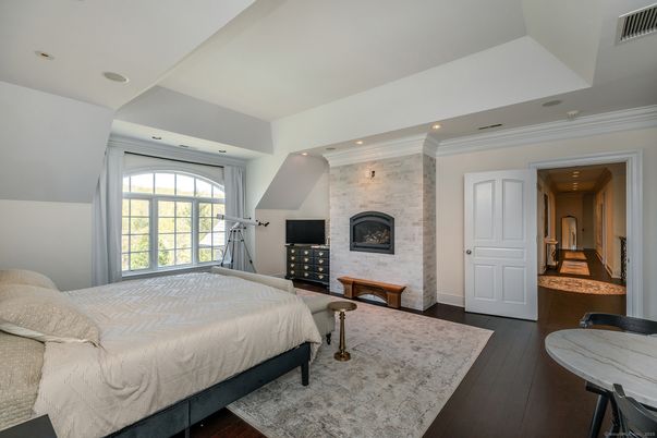 Bedroom, Fireplace, Interior, Recessed Lighting, Stone Walls, Wood Texture Flooring