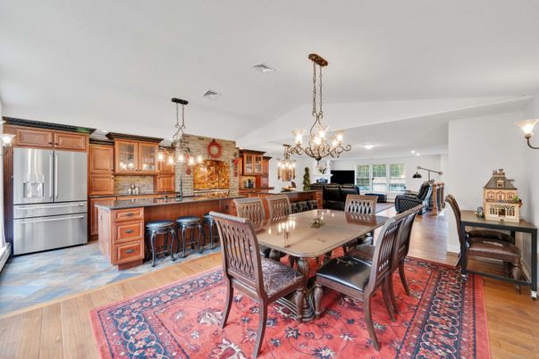 Chandelier, Dining room, Interior, Kitchen, Pendant Lights, Recessed Lighting, Stainless Steel Appliances, Stone Walls, Wood Texture Flooring