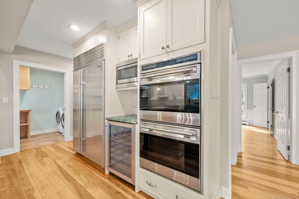 Interior, Kitchen, Recessed Lighting, Stainless Steel Appliances, Washer, Wood Texture Flooring