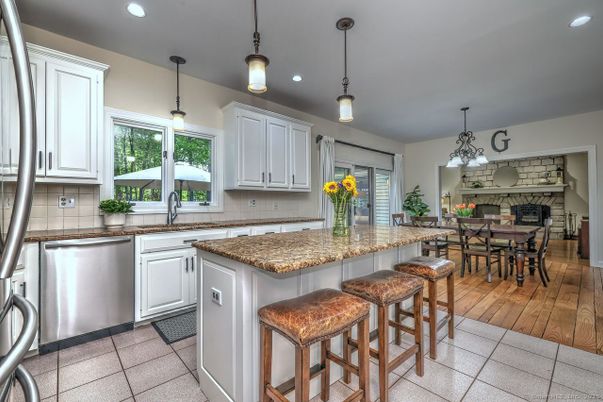 Dining room, Fireplace, Interior, Kitchen, Pendant Lights, Recessed Lighting, Stainless Steel Appliances, Stone Walls, Wood Texture Flooring