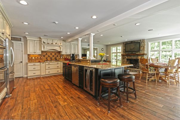 Dining room, Fireplace, Interior, Kitchen, Recessed Lighting, Stainless Steel Appliances, Stone Walls, Wood Texture Flooring