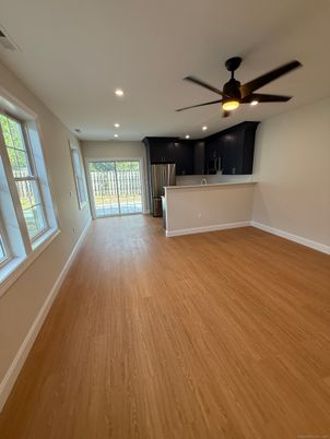 Empty room, Interior, Kitchen, Recessed Lighting, Stainless Steel Appliances, Wood Texture Flooring