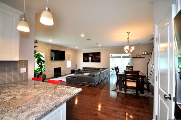 Chandelier, Dining room, Fireplace, Interior, Living room, Pendant Lights, Recessed Lighting, Stone Walls, Wood Texture Flooring