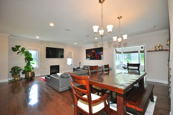 Chandelier, Dining room, Fireplace, Interior, Living room, Pendant Lights, Recessed Lighting, Wood Texture Flooring