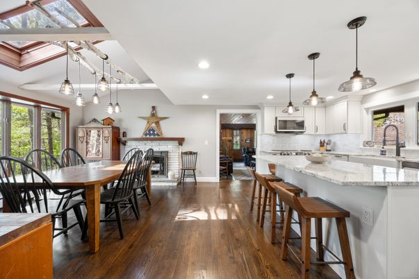 Dining room, Fireplace, Interior, Kitchen, Pendant Lights, Recessed Lighting, Stainless Steel Appliances, Wood Texture Flooring